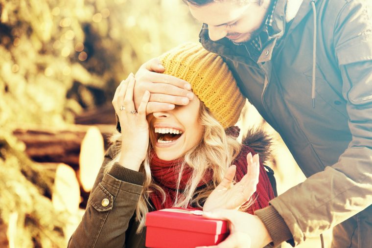 Happy couple giving Christmas gift