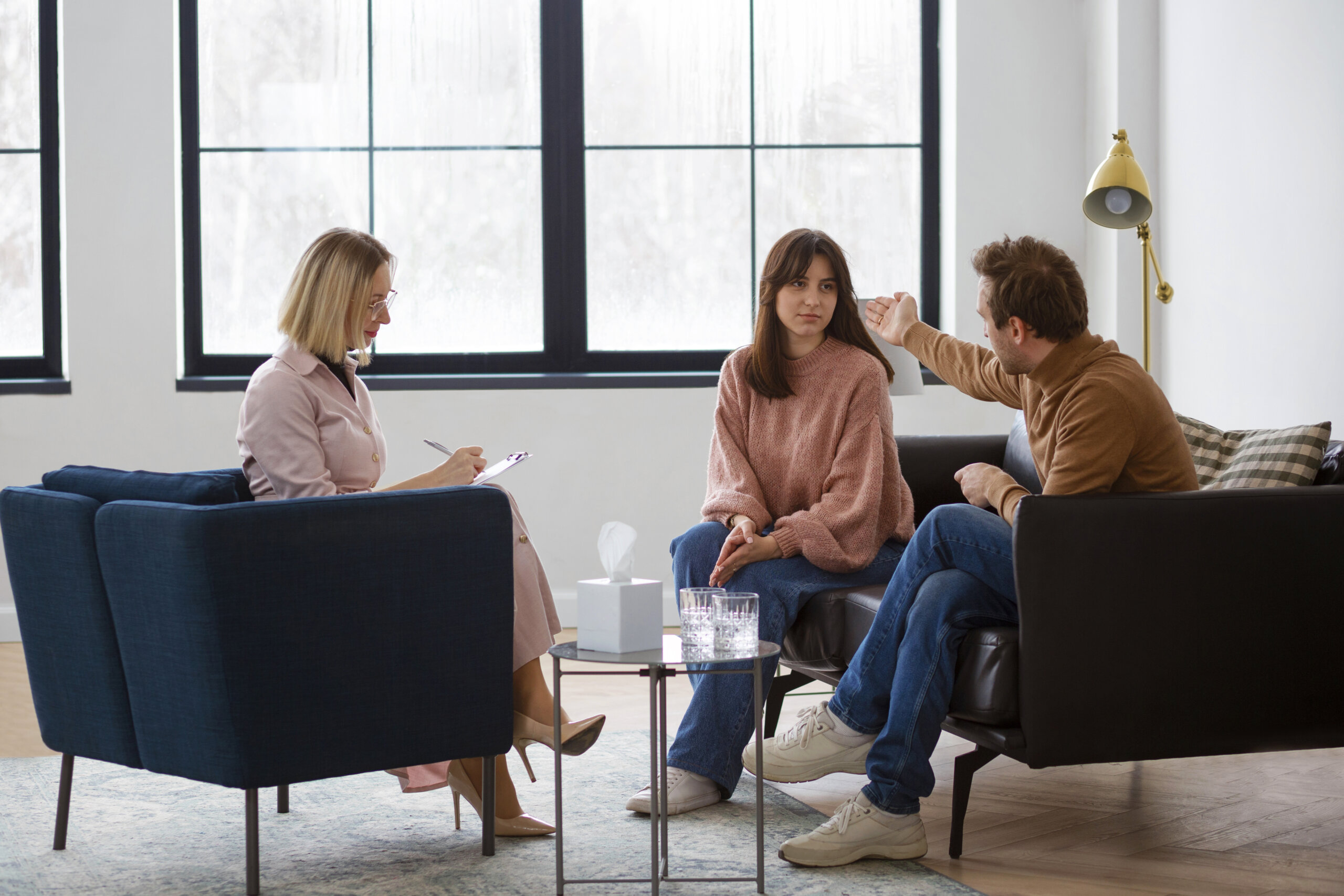 Professional relationship coach meeting with couple during coaching consultation